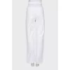 White jeans with cutouts at the waist