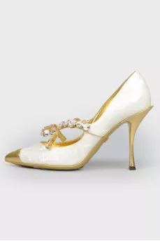 Shoes with a sharp golden toe with a tag