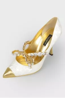 Shoes with a sharp golden toe with a tag