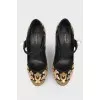 Black and golden shoes with a pearl with a tag