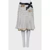 Skirt with frills decorated with brooches