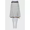 Skirt with frills decorated with brooches