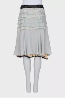 Skirt with frills decorated with brooches