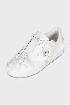 Leather sneakers decorated with a flower