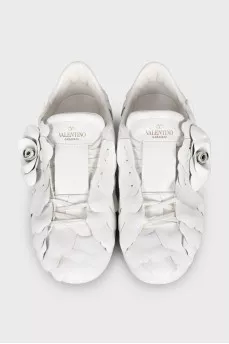 Leather sneakers decorated with a flower