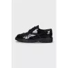 Patent leather shoes with perforations
