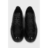 Patent leather shoes with perforations