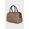 A bag with handles and a strap in a signature print