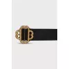 Black leather belt with a shaped buckle