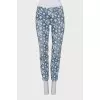Jeans with perforations decorated with embroidery