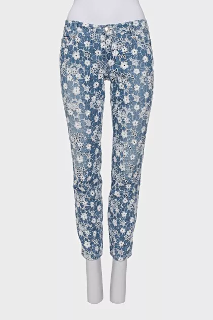 Jeans with perforations decorated with embroidery