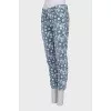 Jeans with perforations decorated with embroidery