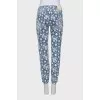 Jeans with perforations decorated with embroidery
