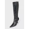 The boots are decorated with hooks