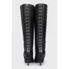 The boots are decorated with hooks