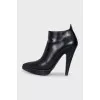 Black leather ankle boots with a slanted heel