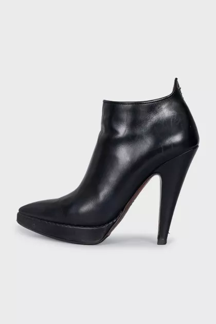 Black leather ankle boots with a slanted heel