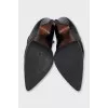 Black leather ankle boots with a slanted heel