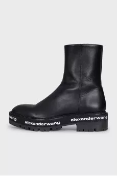 Leather boots with a logo on the sole