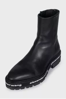 Leather boots with a logo on the sole