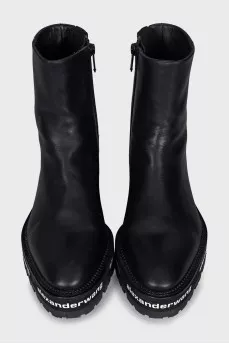Leather boots with a logo on the sole