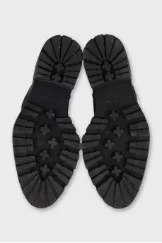 Leather boots with a logo on the sole