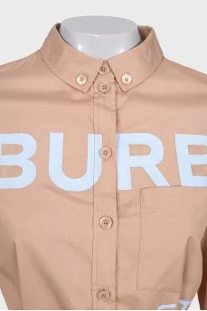 Dress with a buttoned patch pocket