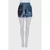 Blue denim shorts with a distressed effect