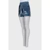 Blue denim shorts with a distressed effect