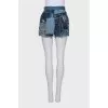 Blue denim shorts with a distressed effect