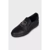 Men's leather slip-ons with a silver logo
