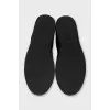 Men's leather slip-ons with a silver logo