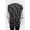 Blouse with a sleeve adjustable in length with a tag
