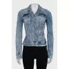The denim jacket is decorated with rhinestones.