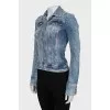 The denim jacket is decorated with rhinestones.