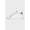 White sneakers with animal print inserts