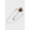 White sneakers with animal print inserts