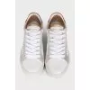 White sneakers with animal print inserts