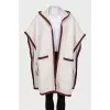 White cape with brand logo