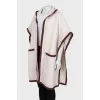 White cape with brand logo
