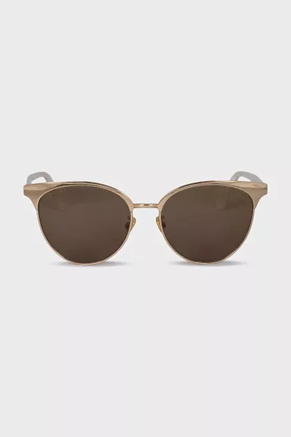 Gold sunglasses with white temples
