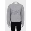 Knitted sweater with decorated logo