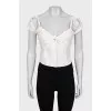 Cropped top decorated with perforations