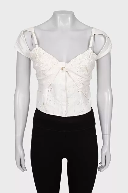 Cropped top decorated with perforations
