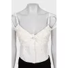 Cropped top decorated with perforations