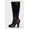 Boots decorated with a leather strap