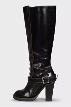 Boots decorated with a leather strap