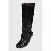 Boots decorated with a leather strap