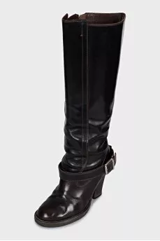Boots decorated with a leather strap