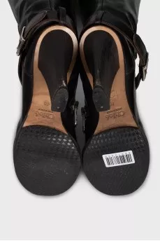 Boots decorated with a leather strap